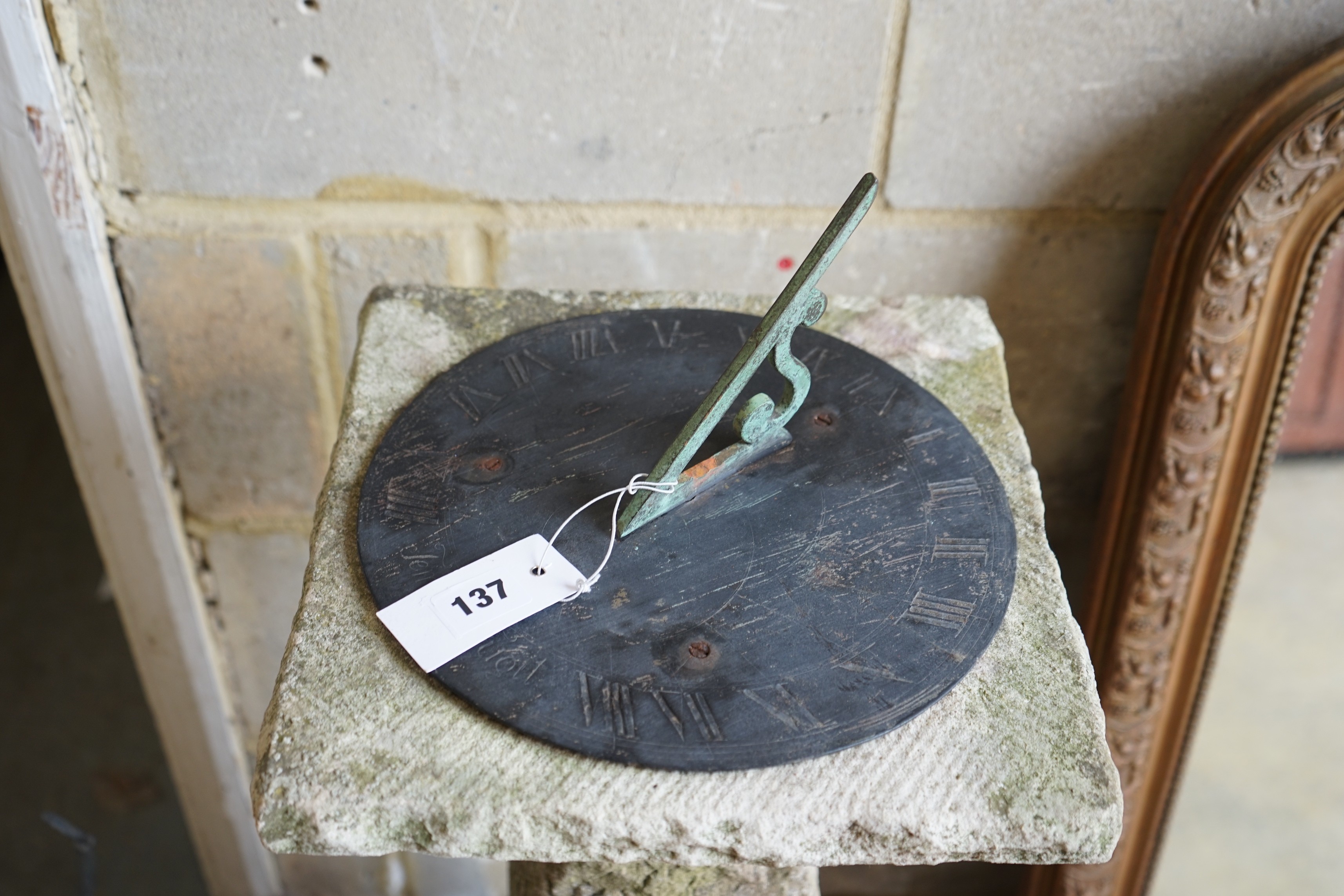 A carved stone sundial with brass dial and gnomon, height 105cm
